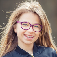 Preteen girl with traditional braces